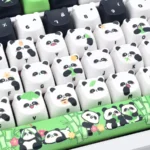 Detailed views of the exquisite handcrafted panda artisan keycap set, showcasing its whimsical miniature sculpture and meticulous black and white design.