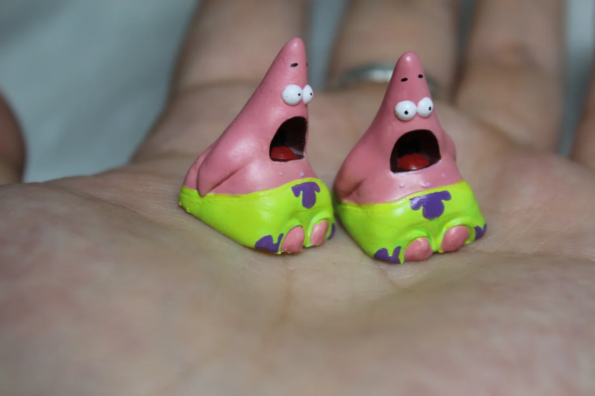 Whimsical handmade pink Patrick Star resin artisan keycap, showcased from various angles to highlight its playful details.