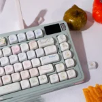 Wind Chime Dream PBT Keycap Set, blue-pink gradient. Whimsical wind chime and cloud motifs. Durable PBT, from multiple angles.