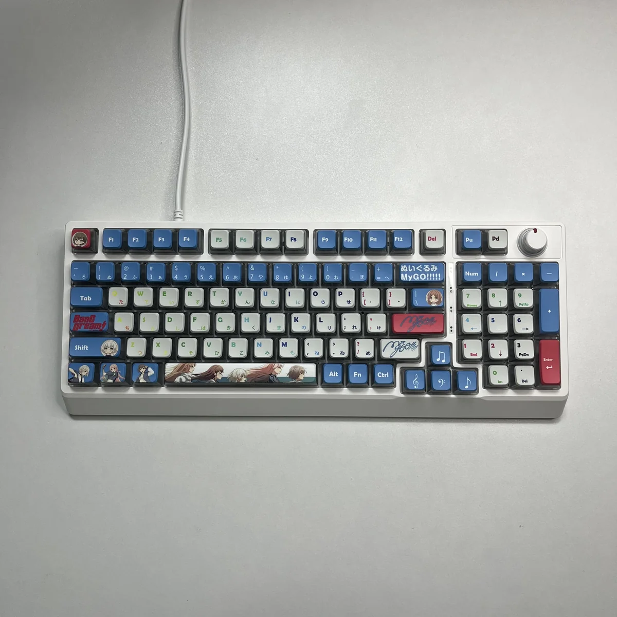 Vibrant RGB PBT MyGO Band Theme keycap set in a playful display, showcasing their immersive glow and comfortable MDA profile on a modern keyboard.