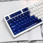 Luminous Acid Blue White PC keycaps set from a unique angle, highlighting the striking translucent blue and opaque white contrast, ready to illuminate..