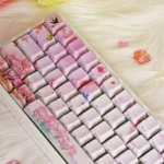 Exquisite Peach Blossom Spring PBT keycaps set from multiple angles, revealing the idyllic ancient Chinese landscape, delicate blossoms, and ethereal utopia.