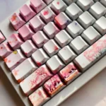 Exquisite Peach Blossom Spring PBT keycaps set, shown from various angles. Features delicate peach blossoms and idyllic ancient Chinese utopia landscape.