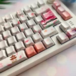 Exquisite Peach Blossom Spring PBT keycap set showcasing idyllic ancient Chinese landscapes and delicate, ethereal peach blossoms from various angles.