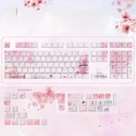 Multiple angles of the exquisite Peach Blossom Spring PBT keycaps set, revealing their ancient utopia design with delicate peach blossoms and ethereal art.