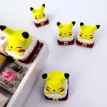Vibrant handcrafted 3D resin Pikachu keycap, shown from various playful angles, highlighting its festive design and artistic charm for mechanical keyboard.