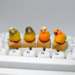 Handmade Pineapple Conure Keycaps, a vibrant miniature tropical scene on a rustic base.