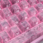 A gallery of Pink Forged Carbon Keycaps Set, showcasing their distinctive high-tech texture and playful elegance from multiple angles.