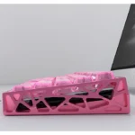 Image of a small full set of PC keycaps set in a distinctive pink forged carbon texture with inscribed legends, embodying playful elegance.