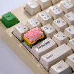 A whimsical pink Pig Pie handcrafted 3D artisan keycap, featuring a glossy food-inspired design for unique mechanical keyboards.