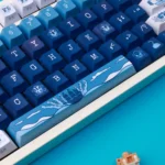 Vibrant blue and white durable PBT Pirate Keycaps set, playfully showcasing their swashbuckling Caribbean theme from different angles.