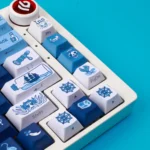 Durable PBT Pirate Keycaps Set, shown from various angles. These playful blue and white keycaps feature a nautical theme, perfect for a vibrant design lovers.