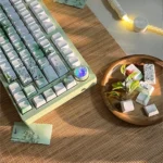 Poetic Chinese Landscape PBT keycaps set, shown from various angles, display serene ink wash art and traditional motifs. An artistic Chinese keycap set.