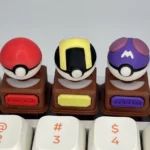 Vibrant product gallery of iconic 3D Pokemon keycaps, featuring detailed sculpted replicas of Poke ball, Great, and Master Balls shown from multiple angles.
