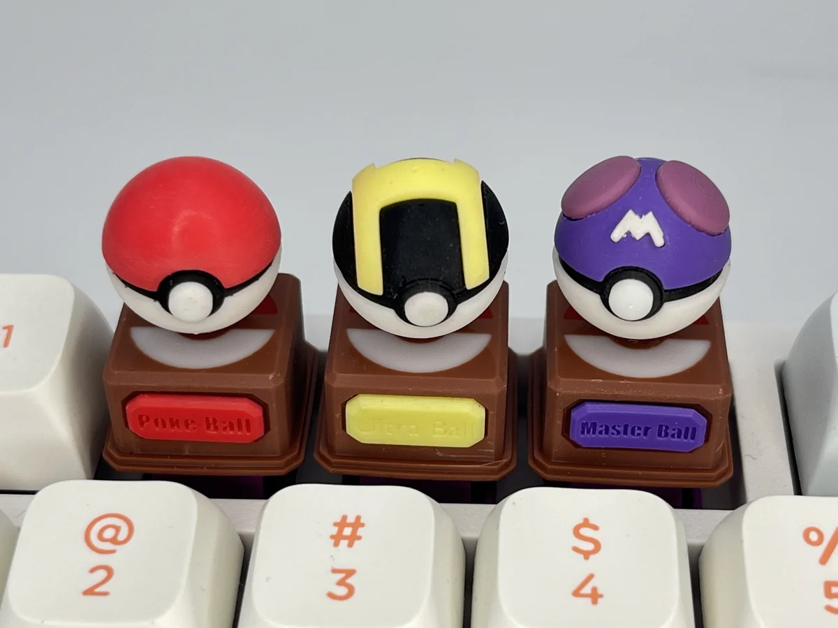 Vibrant product gallery of iconic 3D Pokemon keycaps, featuring detailed sculpted replicas of Poke ball, Great, and Master Balls shown from multiple angles.