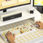 A collection of adorable Pompompurin PBT keycaps set from various angles, showcasing the cheerful yellow and brown designs and durable quality.