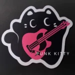 Rebellious Charm Punk Kitty Mouse Pad, shown from a new angle, featuring its unique irregular shape and playful black and pink punk cat design.