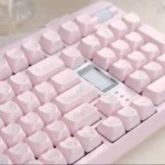 Exquisite Rococo Angel pearlescent PBT keycap set, seen from various angles. Showcases ornate angelic details, delicate pastel hues, and shimmering finish.