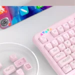 Artistic close-up of an exquisite ethereal Rococo angel keycap set in shimmering pearlescent white, highlighting its delicate ornate details.