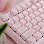 Exquisite pearlescent pink Rococo angel keycap set, displaying its delicate pastel hues, shimmering finish, and ornate angelic design.