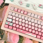 A collection of charming Pink Rose Bunny PBT keycaps set from the Garden Set shown from various angles, featuring whimsical rabbit and pastel rose designs.