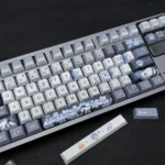 Main display of the exclusive Shaw Keycap Set, a sleek, dark, and mysterious artistic tribute showcasing unique character motifs.