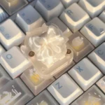 Ethereal handcrafted silk butterfly keycap shown from multiple angles, showcasing its delicate silk bow artisan detail. A whimsical, high-quality accessory.