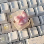Close-up images of the ethereal handcrafted silk butterfly artisan keycap, showcasing delicate silk bow details and whimsical garden fantasy design.