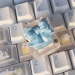 Detailed gallery views of the ethereal handcrafted silk butterfly keycap, highlighting its soft silk bow and intricate artisan butterfly design from various angles.