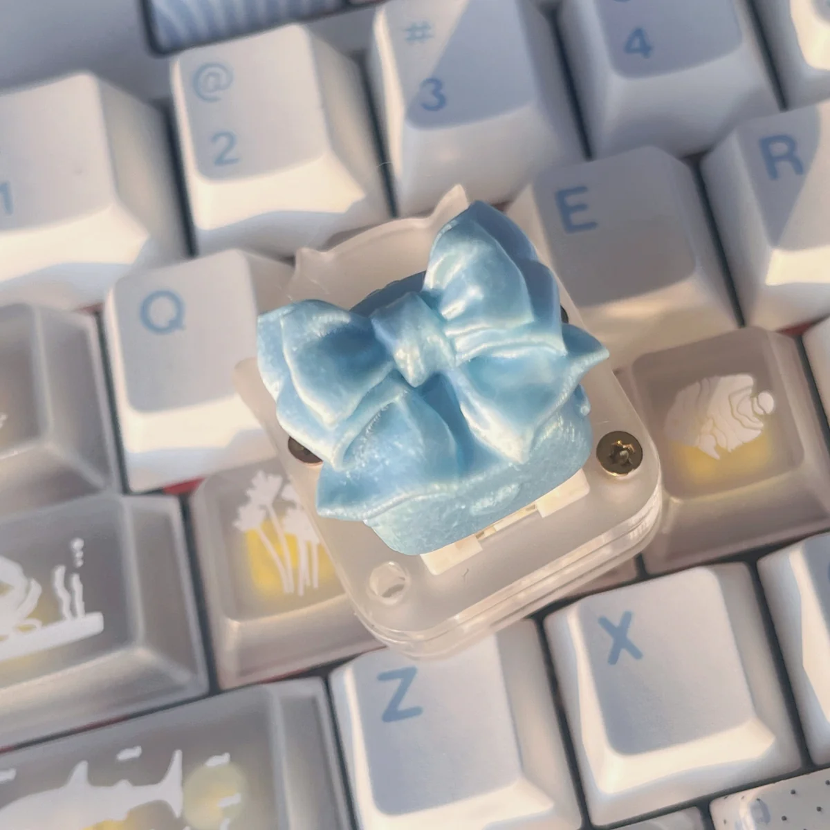Detailed gallery views of the ethereal handcrafted silk butterfly keycap, highlighting its soft silk bow and intricate artisan butterfly design from various angles.