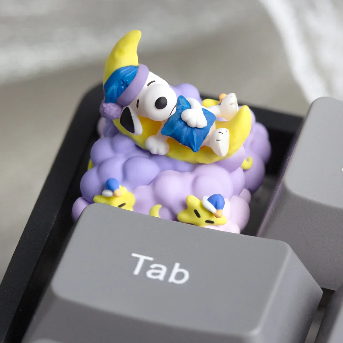Handcrafted Snoopy Moon artisan resin keycap featuring whimsical Snoopy playfully perched on a dreamy crescent moon, a celestial art piece.