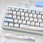 Whimsical snowman mechanical keycaps from various angles. Shows playful blue and white winter wonderland designs, charming snowmen and snowflakes.