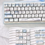 Whimsical snowman mechanical keycap from a new angle, showing its charming blue and white winter design with playful snowmen and snowflakes.