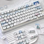 Whimsical little snowman mechanical keycaps, showcasing a charming blue and white winter wonderland design with playful snowflake accents.