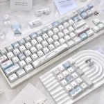 Whimsical Little Snowman 147-key mechanical keycaps, showcasing a charming blue and white winter wonderland design with playful snowflake accents.