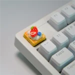 Handmade strawberry mille-feuille artisan keycap, revealing hyper-realistic vibrant pink and cream dessert layers from artistic angles.