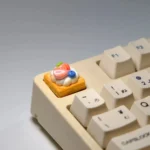 Handmade strawberry mille-feuille artisan keycap from various angles, showcasing vibrant pink and cream layers and hyper-realistic dessert art.
