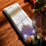 A playful pastel Stylish X100Pro Tri-Mode Membrane Keyboard, detailed from a charming angle, showcasing its silent tri-mode features, cute cat keycaps, and soft RGB illumination.