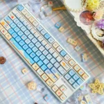 Multiple angles of serene summer beach PBT dye-sub keycaps set, showcasing vibrant ocean and sand motifs for a tranquil keyboard escape.