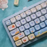 MOA profile opaque PBT dye-sub keycaps set capturing a vibrant summer beach, with azure waters and playful motifs for a serene keyboard escape.
