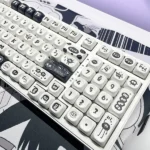 Whimsical Susuwatari PBT Dye-sub keycaps set. Enchanting dark characters on minimalist backgrounds reveal nostalgic charm from all angles.