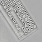 Whimsical Ghibli Susuwatari PBT dye-sub keycaps set, showing various angles. Dark background, playful Soot Sprites for a nostalgic keyboard.