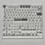 A gallery of whimsical Ghibli Susuwatari PBT Dye-sub keycaps set, showing enchanting characters from multiple angles against a minimalist backdrop.