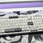 Whimsical Ghibli Susuwatari PBT dye-sub keycaps set, showing various angles. Dark background, playful Soot Sprites for a nostalgic keyboard.