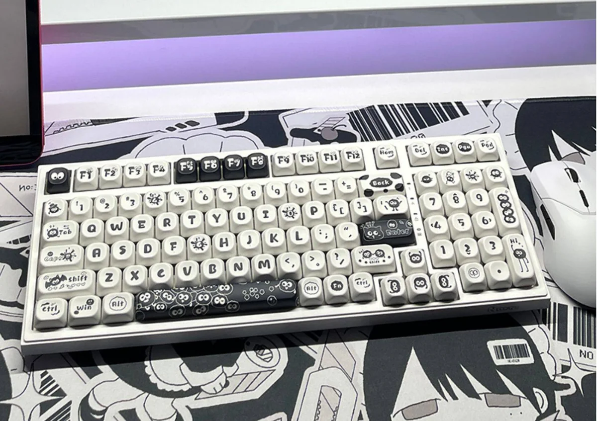 Whimsical Ghibli Susuwatari PBT dye-sub keycaps set, showing various angles. Dark background, playful Soot Sprites for a nostalgic keyboard.