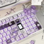 Gallery views of the handcrafted Ethereal Swan Realm Keycap Set, highlighting its ethereal swan motif, translucent amber, and deep purple double-layer art.