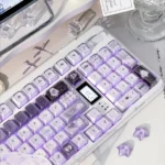 Handcrafted Ethereal Swan Realm Keycap Set showcasing its translucent amber and deep purple double layers, an artistic and unique design.