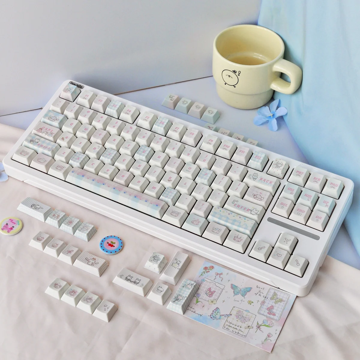 Sweet marshmallow PBT dye-sub keycaps set in a gallery view, highlighting whimsical pastel hues and cozy designs from different angles.