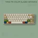 Tang Tri-Color Uyghur PBT keycaps set, artfully displayed from various angles, highlighting its rich earthy glazes and unique Uyghur legends.