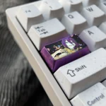 Reze Titanium Keycap from a different angle, showcasing its exquisite anodized purple ice crystal artistry and premium titanium alloy construction.